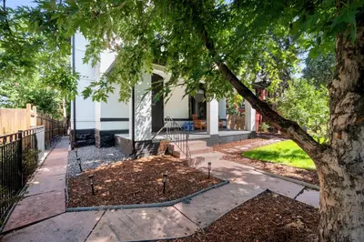 a tree in front of a house at Broadway Dog-Friendly Loft with Parking in Denver