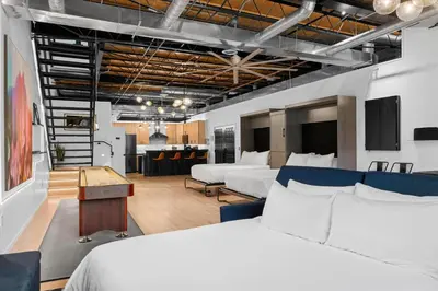 a hotel room with two beds and a kitchen at Suite No 1 & No 2 in Denver