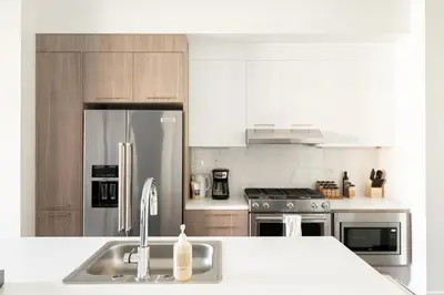 a kitchen with a sink and a stainless steel refrigerator at Relaxed Elegance at Espadin in Denver