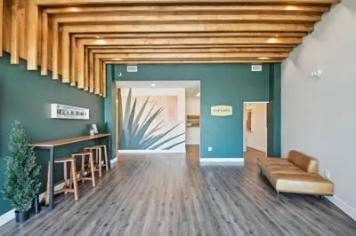 a lobby with green walls and a wooden ceiling at Art Inspired Retreat at Espadin in Denver