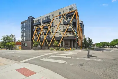 a large building on the corner of a street at Sleek & Chic Comforts at Espadin in Denver