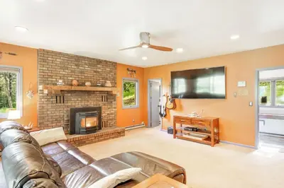 a living room with a couch and a fireplace at The Evergreen Oasis I Red Rocks I Morrison in Morrison