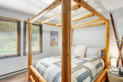 a bedroom with a bed with a wooden bed frame at The Evergreen Oasis I Red Rocks I Morrison in Morrison
