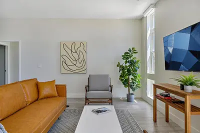 a living room with a couch and a table at 2880 Modern Lifestyle Loft at Espadin in Denver