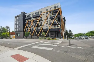a large building on the corner of a street at 2880 Sky-High LoHi Oasis at Espadin in Denver