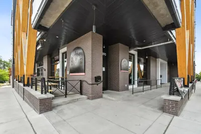 a brick building with a black roof at 2880 Sky-High LoHi Oasis at Espadin in Denver