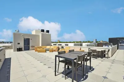 a patio with a table and chairs on a roof at 2880 Sky Edge Suite at Espadin in Denver