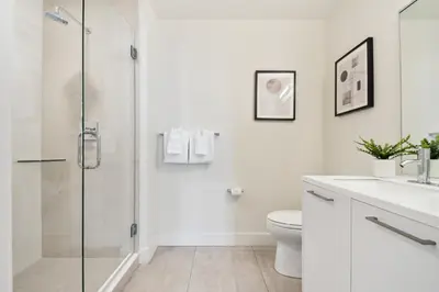 a white bathroom with a shower and a toilet at 2880 Enchanting Moroccan Oasis in Denver