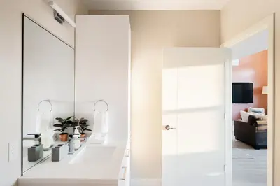a mirror in a living room next to a door at 2880 Bold & Elevated in Denver