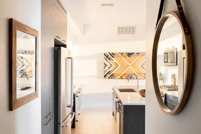 a kitchen with a sink and a mirror at 2880 Bold & Elevated in Denver