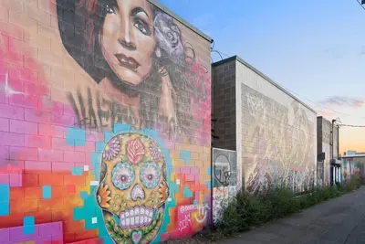 a mural of a woman with a skull on a wall at 3198 Urban Cowboy Escape at RiNo Art Lofts in Denver