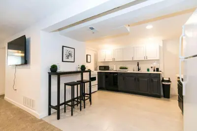 an empty kitchen with black counter stools in a room at Near Downtown Denver A Huge Home With Two Kitchens in Denver