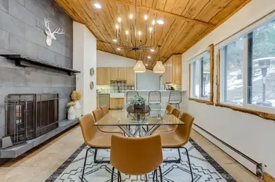 a dining room with a glass table and chairs at Mountain Mansion With A Hot Tub And A Sauna in Morrison