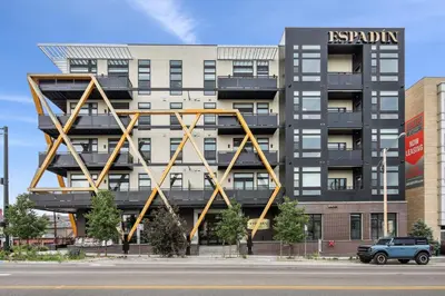 a building with a large metal structure on the side of it at 2880 U505 Skytop Perspective at Espadin in Denver