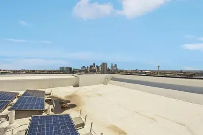 a rooftop with solar panels and a view of the city at 2880 U505 Skytop Perspective at Espadin in Denver