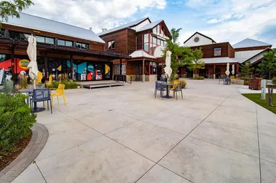 a patio with chairs and tables in front of a building at CSU Hideaway with King Bed, Backyard Oasis in Fort Collins
