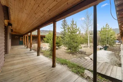 a wooden porch of a house with a deck at Grand Lake Haven in town, Osprey Studio Cabin in Grand Lake