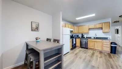 a kitchen with a table and chairs in a room at Convenient two bedroom near DIA in Brighton