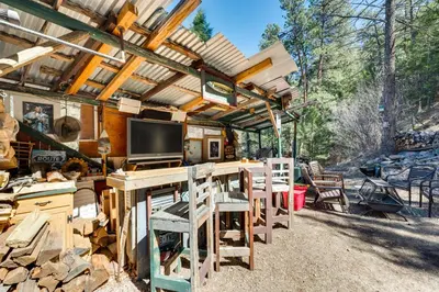 a kitchen with a table and chairs under a pergola at Private Hot Tub and Deck Riverfront Escape in Drake in Drake