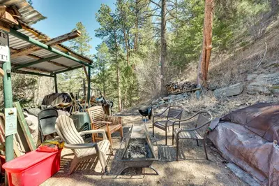 a group of chairs and a table on a patio at Private Hot Tub and Deck Riverfront Escape in Drake in Drake