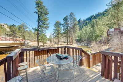 a patio with a table and chairs on a deck at 4 Mi to Downtown Estes Park Nature Retreat in Drake
