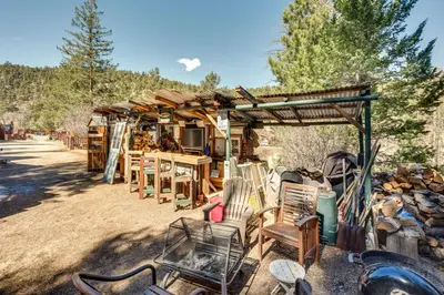 a group of chairs and tables and a wooden building at Fish, Hike and Unwind Drake Cabin with Hot Tub! in Drake