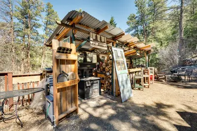 a wooden building with a stove in a yard at Private Hot Tub and Fishing On-Site Cabin in Drake in Drake