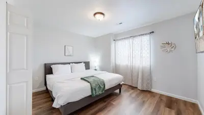 a white bedroom with a bed and a window at Great Two King Bed Rooms Near Airport Ideal Stay in Brighton