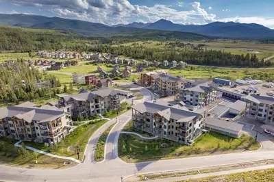 an aerial view of an apartment complex with mountains in the background at Downtown Fraser with Hot Tub in Fraser