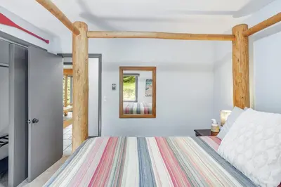 a bedroom with a bed with a wooden frame at The Four Pines Near to Red Rocks And Morrison in Morrison