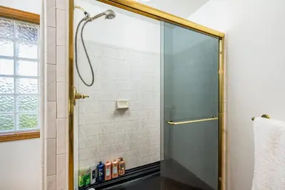 a shower with a glass door in a bathroom at 5 Bedroom Whole Home with Mountain Views in Evergreen