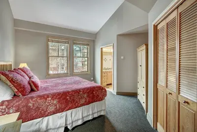a bedroom with a red bed and a window at Fantastic Mountain Home Near Ski Lifts condo in Keystone