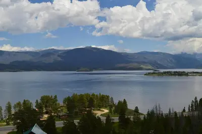 a view of a large lake with trees and mountains at Blackhawk in Grand Lake