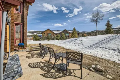 a patio with chairs and a table and snow at 3BDR with Loft for 8 Hot Tub Sauna & Mtn Views in Breckenridge