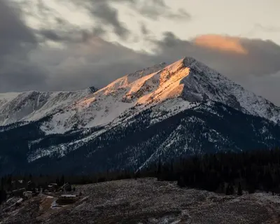 a mountain covered in snow with the sun shining on it at Perfect Getaway Cabin with Nearby Hike&Bike Trails in Breckenridge