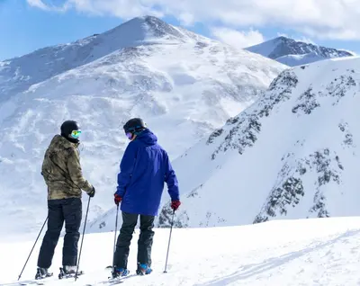 two people on skis on a snow covered mountain at Rock Wren Poolside - 3 BDR Condo in Keystone