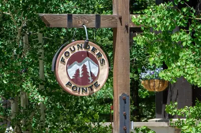 a sign for a forest outlet hanging from a pole at Founders Pointe 4473 Ski In Ski Out Winter Park Resort in Winter Park