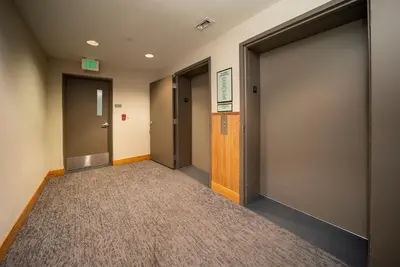 a hallway with two elevators and a door at Fraser Crossing 3227 Ski In Ski Out Winter Park Resort in Winter Park