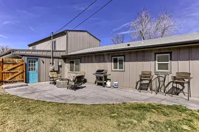 a house with a patio with chairs and a grill at Spacious and Quiet Retreat - Firepit and Yard in Denver