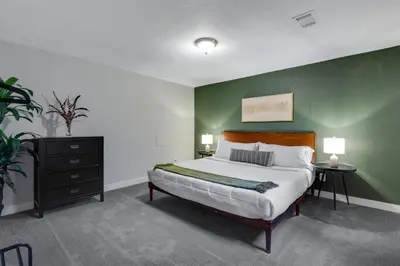 a bedroom with a large bed with a green wall at Mid Summer Night's Dream w/HotTub&Theater in Arvada
