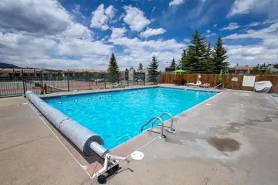 a large swimming pool with blue water at Outdoor Pool, Fireplace, Athletic Club, Covered Balcony with Views in Fraser