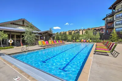 a large swimming pool with colorful chairs in a building at Granby Ranch Escape Shuttle to the Slopes! in Granby