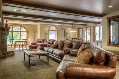 a living room with a leather couch and a table at Red Hawk Lodge 2267 in Keystone