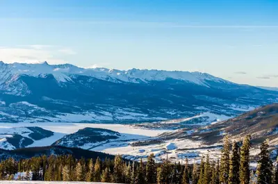 a view of a snowy mountain range with a lake at Gateway 5053 in Keystone