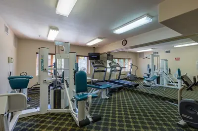 a gym with treadmills and machines in a room at Gateway 5097 in Keystone
