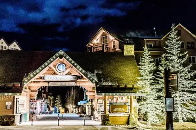 a building with a christmas tree in front of it at Red Hawk Lodge 2312 in Keystone