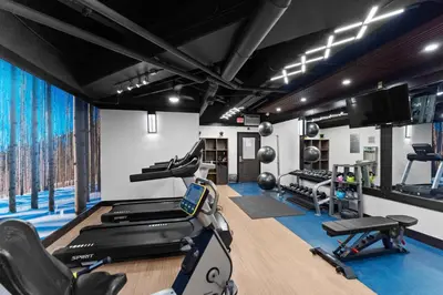 a gym with treadmills and exercise equipment in a room at Silver Mill 8266 in Keystone