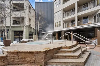 a hot tub in a courtyard in front of a building at Silver Mill 8171 in Keystone