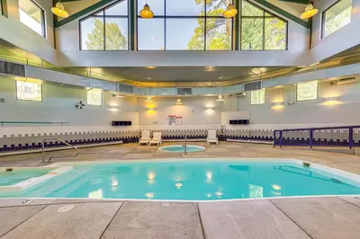 a large swimming pool in a building with windows at Close to Rocky Mtn Slopes! Cozy Silverthorne Condo in Silverthorne