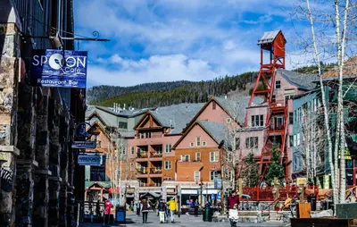 a group of people walking down a street in a town at Timbers 3074 in Keystone